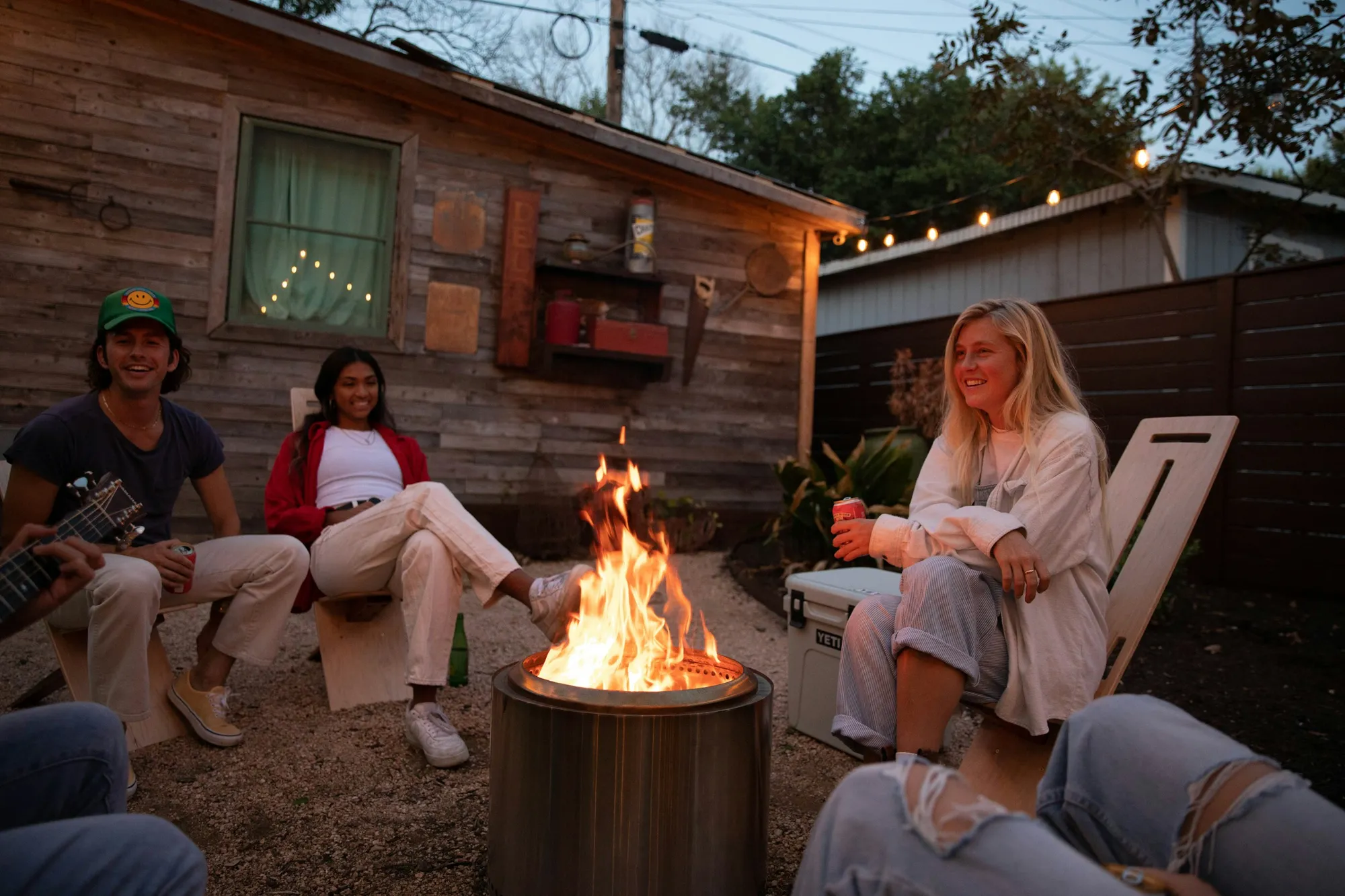 Friends gathered around a fire, sharing life together